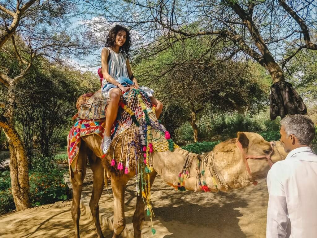 Kate enjoying a unique experience riding a camel, a popular activity in New Delhi.