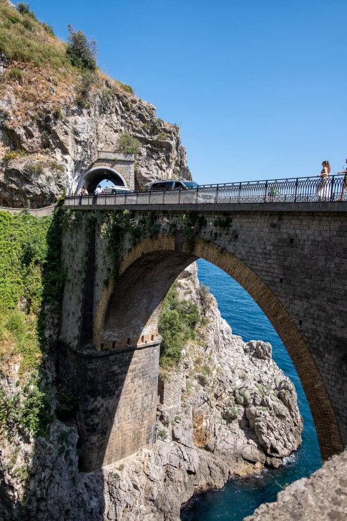 Architectural marvel Fiordo di Furore Bridge spans gracefully, framing the azure waters beneath, a picturesque sight in the Amalfi Coast region.