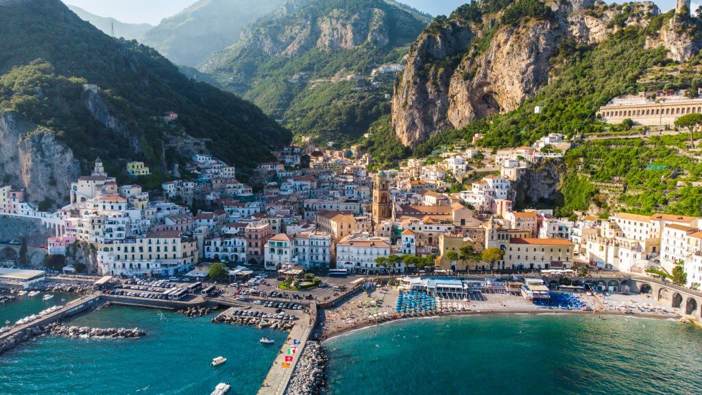 Drone capture of the mesmerizing Amalfi Coast, offering panoramic views and adventure ideas for those exploring beyond Napoli.