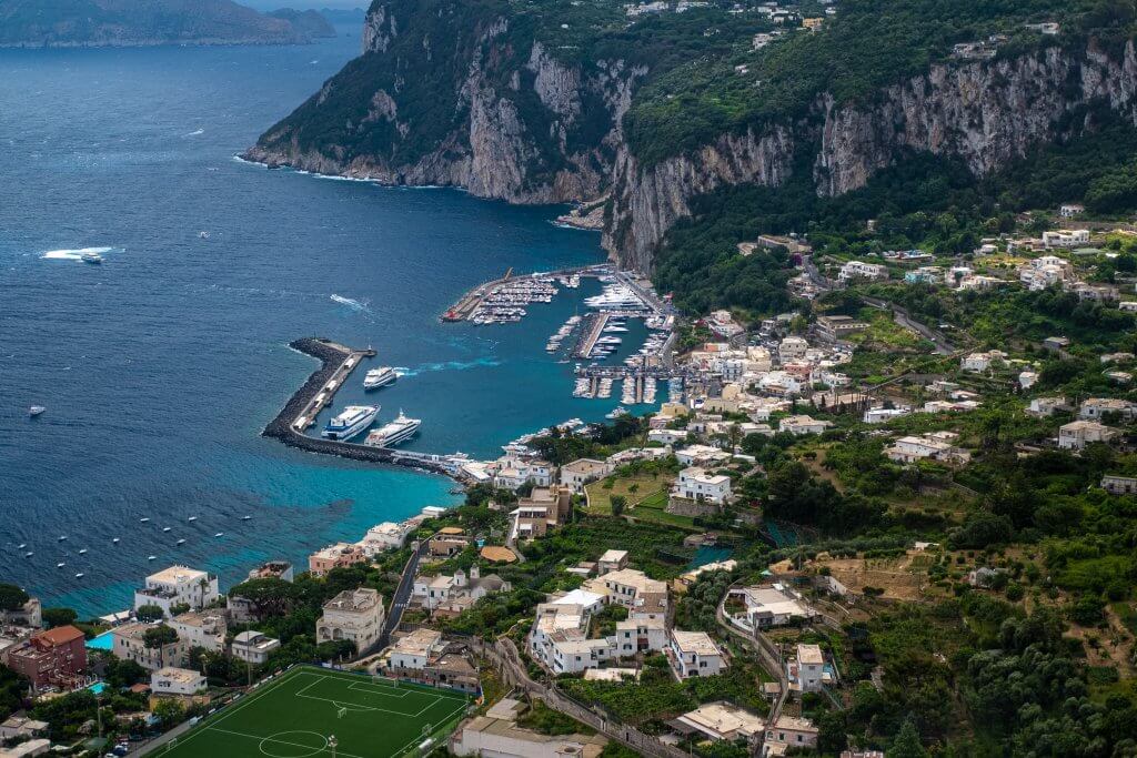 Breathtaking view of Porto Turistico di Capri from the mountain heights, highlighting the scenic tourist attractions in Capri.